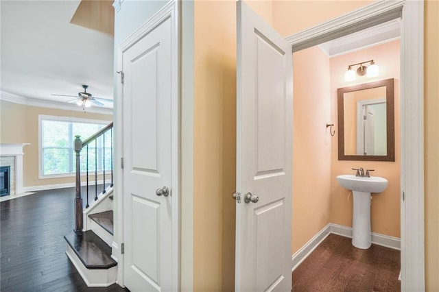 11686 Davenport Ln, Alpharetta, GA 30005 - hallway with ornamental molding, baseboards, dark wood finished floors, stairs, and a sink