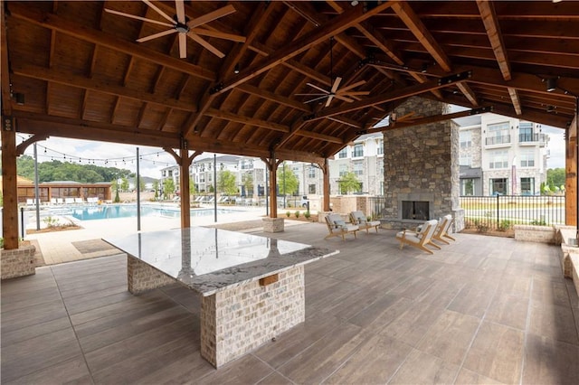 5440 Howington Ct Unit 190, Buford, GA 30518 - view of patio / terrace with an outdoor stone fireplace and a ceiling fan