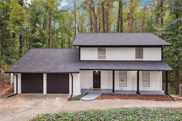 view of front of home featuring a porch and a garage