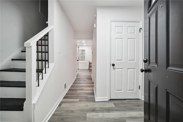 entryway with hardwood / wood-style flooring