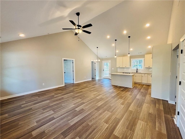 kitchen with white cabinets, wood finished floors, open floor plan, and a center island