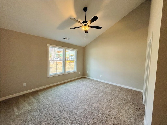 carpeted spare room featuring visible vents, lofted ceiling, baseboards, and ceiling fan