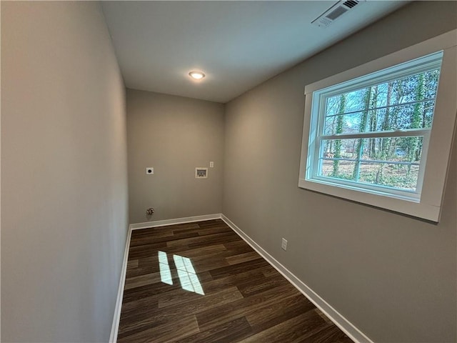 washroom featuring dark wood finished floors, baseboards, hookup for an electric dryer, hookup for a washing machine, and laundry area