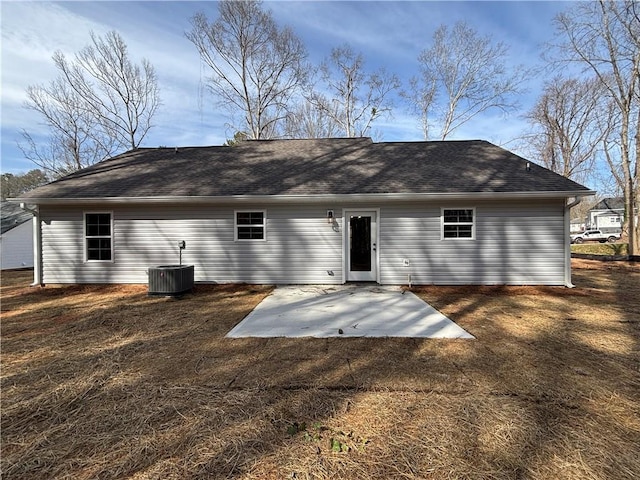 back of house featuring a patio area, a lawn, central AC, and roof with shingles