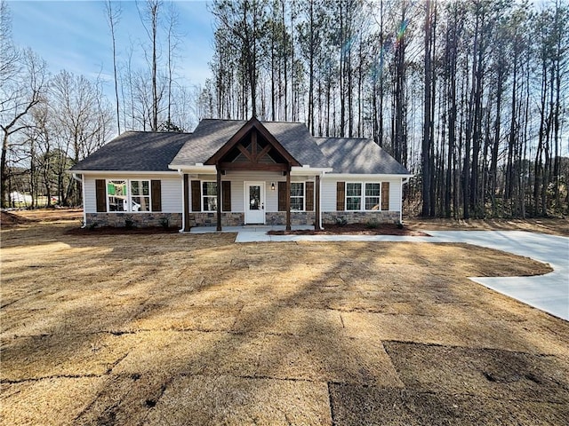 craftsman house with stone siding and a porch