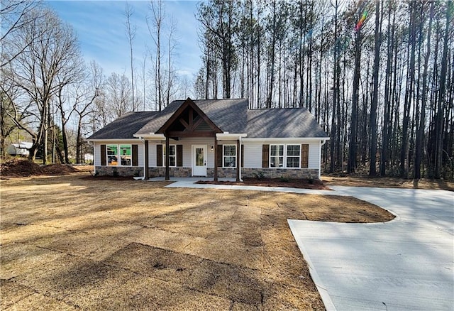 craftsman house featuring stone siding