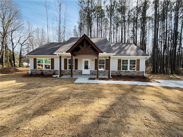 craftsman house featuring stone siding and a porch