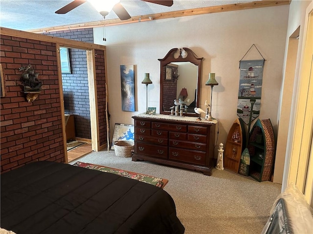 bedroom with light colored carpet, ceiling fan, and brick wall