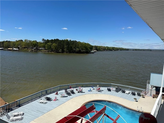 view of dock featuring a water view and a community pool