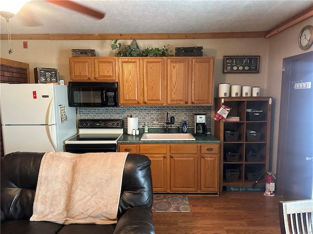 kitchen featuring white refrigerator, sink, decorative backsplash, range with electric cooktop, and dark wood-type flooring