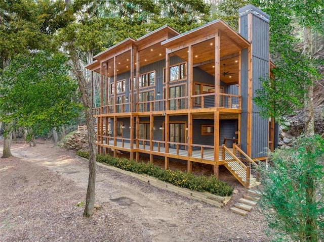 rear view of house with ceiling fan