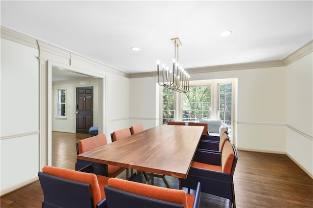 dining room featuring plenty of natural light, wood finished floors, a chandelier, and ornamental molding