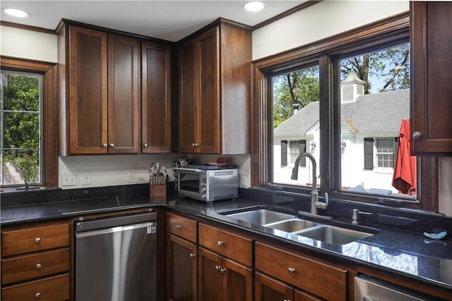 kitchen with recessed lighting, a toaster, dark stone countertops, dishwasher, and a sink