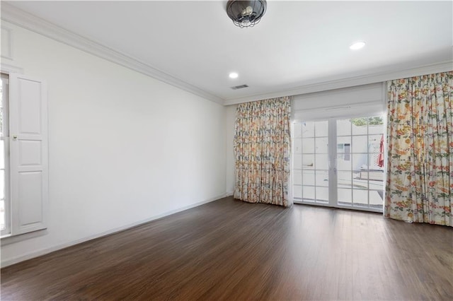 empty room featuring recessed lighting, wood finished floors, baseboards, and ornamental molding