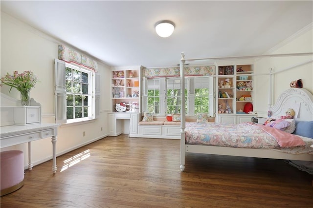 bedroom with wood finished floors and ornamental molding