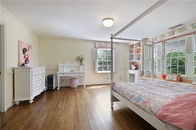 bedroom featuring baseboards, wood finished floors, and ornamental molding