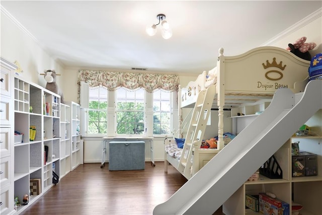 bedroom with dark wood-style flooring, crown molding, and visible vents