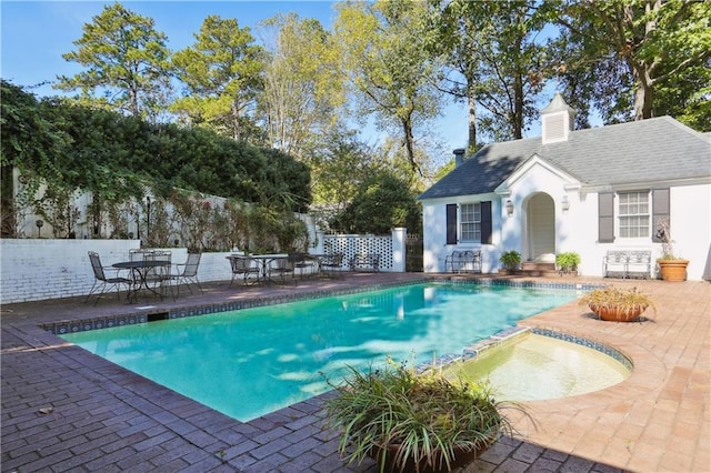view of swimming pool with an exterior structure, a patio area, an outbuilding, and fence