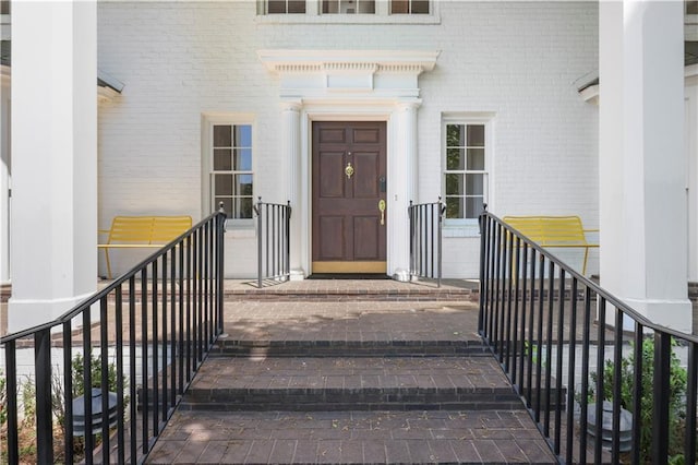 property entrance featuring brick siding