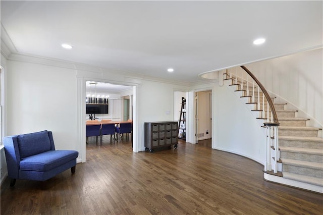 living area featuring crown molding, wood finished floors, stairs, and recessed lighting