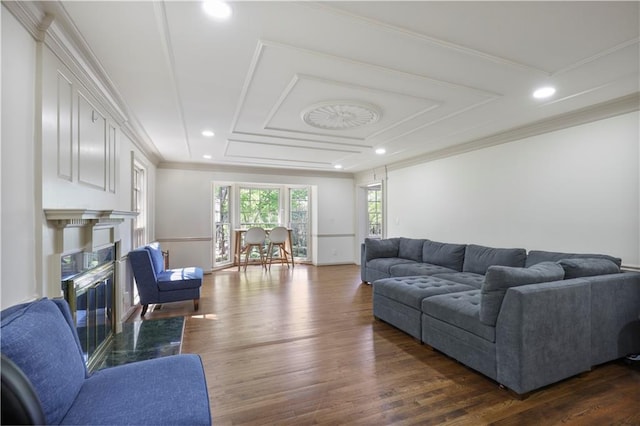 living area with recessed lighting, a high end fireplace, dark wood-style floors, and ornamental molding