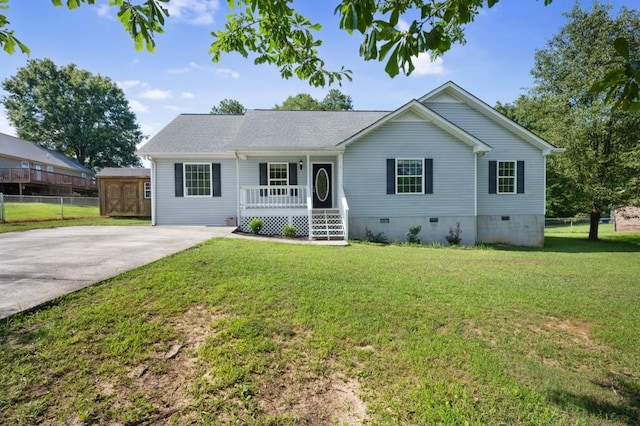 ranch-style house featuring a porch, crawl space, a front lawn, and fence