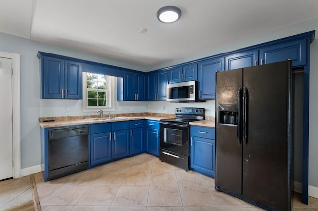 kitchen with light countertops, a sink, black appliances, blue cabinets, and baseboards