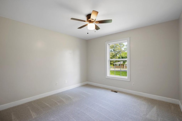 unfurnished room with light carpet, ceiling fan, visible vents, and baseboards