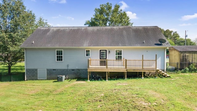 back of house featuring central AC, a yard, a deck, and roof with shingles