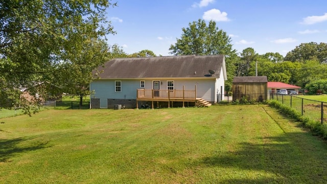 rear view of property with a deck, a yard, and a fenced backyard