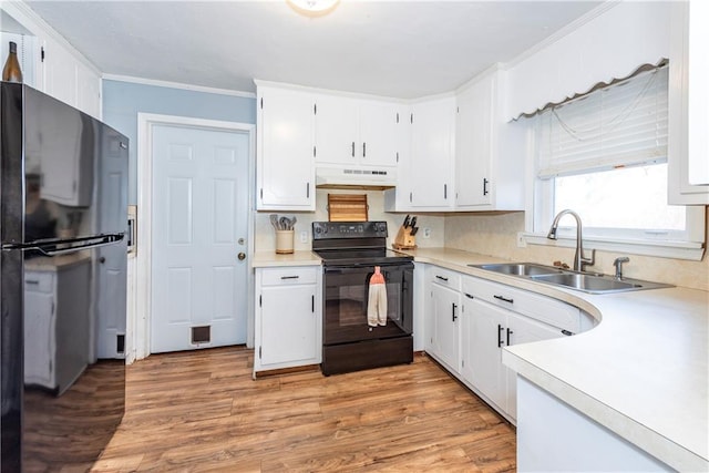 kitchen featuring white cabinetry, light hardwood / wood-style floors, sink, and black appliances