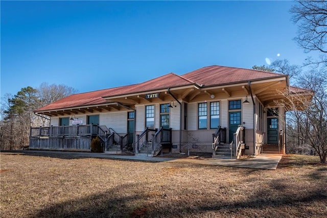 back of property featuring a lawn