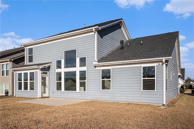 back of house with a lawn and a patio area