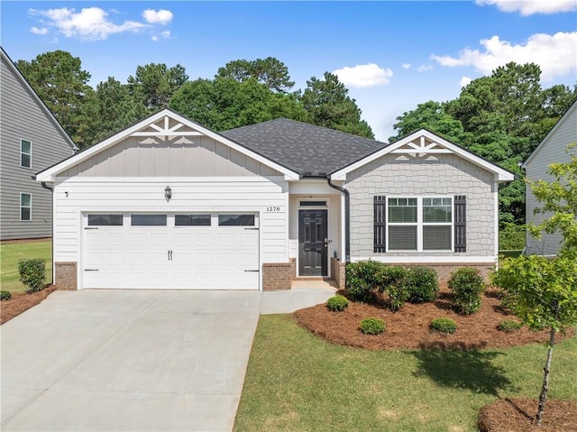 1278 Daurian Dr, Statham, GA 30666 - view of front of house with brick siding, a garage, driveway, a front lawn, and a shingled roof