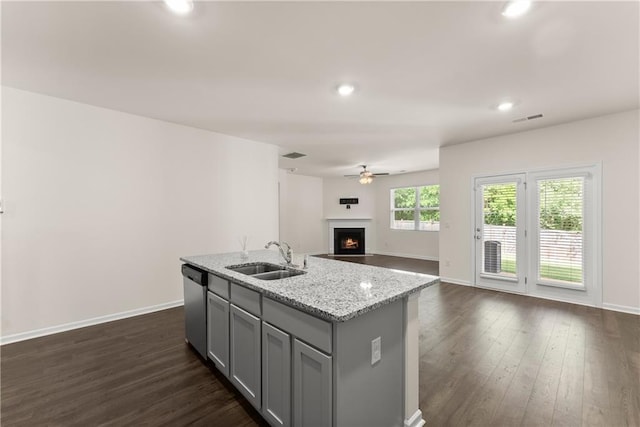 1278 Daurian Dr, Statham, GA 30666 - kitchen with gray cabinets, dishwasher, a ceiling fan, a lit fireplace, and open floor plan