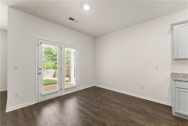 1278 Daurian Dr, Statham, GA 30666 - unfurnished dining area featuring dark wood-type flooring and baseboards