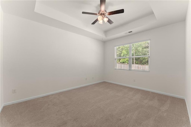 1278 Daurian Dr, Statham, GA 30666 - spare room with a tray ceiling, a ceiling fan, and light carpet