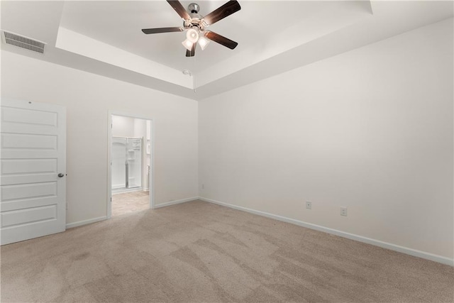 1278 Daurian Dr, Statham, GA 30666 - empty room featuring a tray ceiling, ceiling fan, and light colored carpet