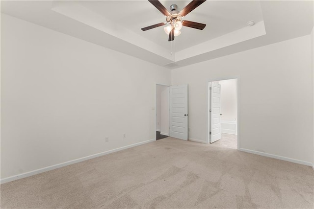 1278 Daurian Dr, Statham, GA 30666 - spare room with a tray ceiling, a ceiling fan, and light carpet
