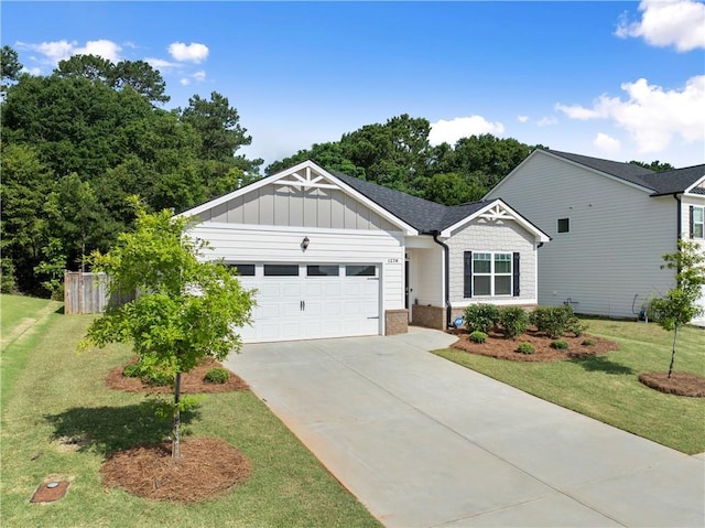 1278 Daurian Dr, Statham, GA 30666 - view of front of house featuring a garage, a front yard, driveway, and brick siding