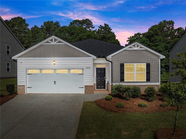 1278 Daurian Dr, Statham, GA 30666 - view of front of home with brick siding, concrete driveway, a garage, a yard, and board and batten siding