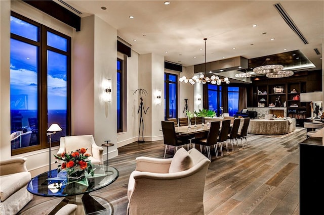 interior space with an inviting chandelier, wood finished floors, and recessed lighting