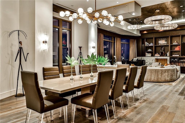 dining room featuring light wood finished floors, baseboards, and visible vents