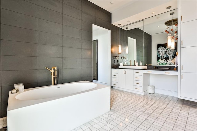 full bathroom with tile patterned flooring, a freestanding bath, tile walls, and vanity