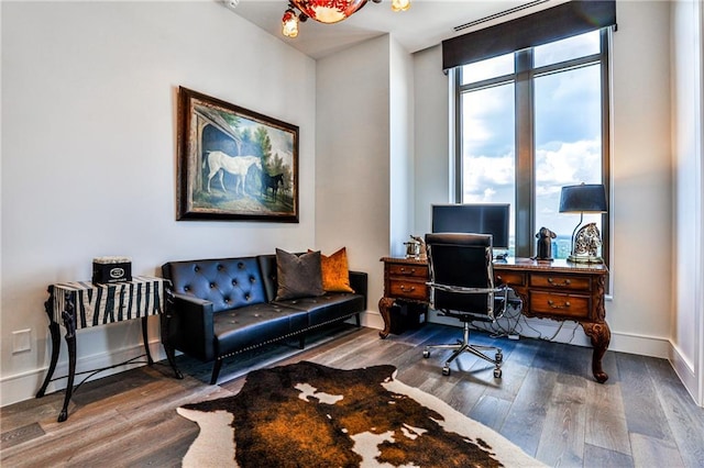 office area with baseboards and wood finished floors