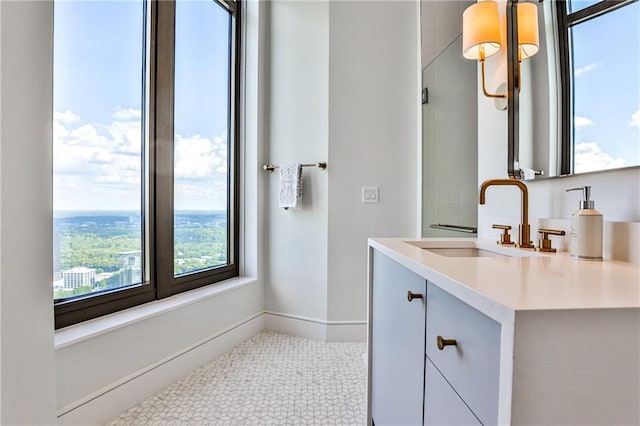 bathroom featuring tile patterned floors, baseboards, and vanity