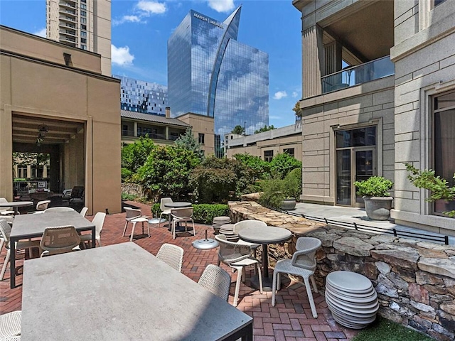 view of patio / terrace featuring outdoor dining space and a view of city