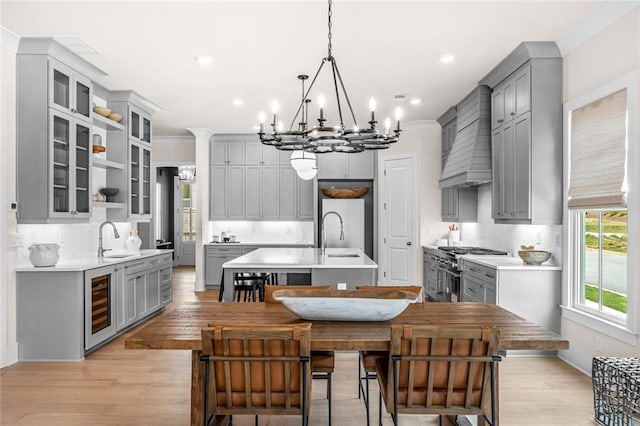 2031 Crossroads Trl, Milton, GA 30004 - kitchen featuring gray cabinetry, high end range, a chandelier, an island with sink, and recessed lighting