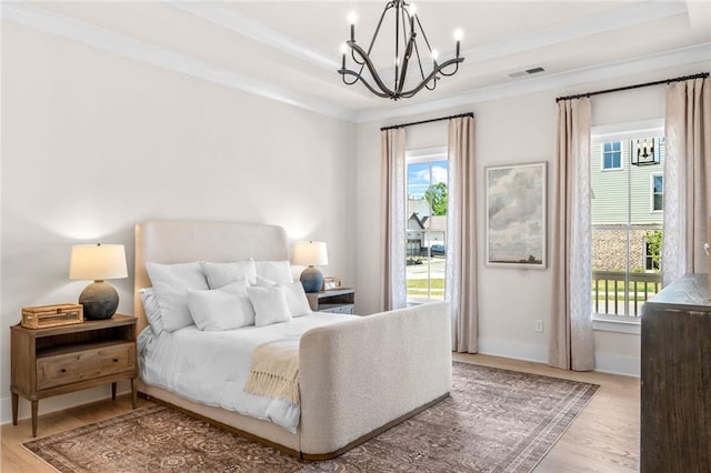 2031 Crossroads Trl, Milton, GA 30004 - bedroom with a chandelier, wood finished floors, multiple windows, ornamental molding, and a raised ceiling