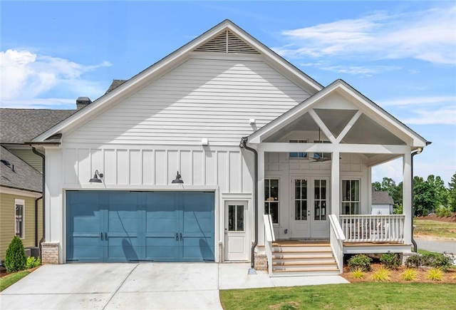 2031 Crossroads Trl, Milton, GA 30004 - view of front of house featuring french doors, board and batten siding, an attached garage, and driveway